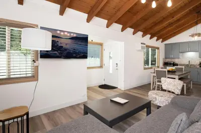 a living room with a couch and a table at Sweet Retreat Combo- Relaxing Resort Cottage Combo in Big Bear Lake