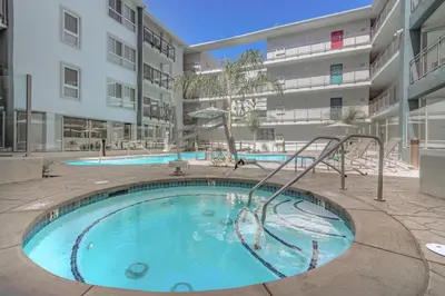 a swimming pool in an apartment building with a slide at Lux Oasis in West Hollywood, Free Parking & Swimming pool in Los Angeles