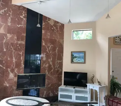 a living room with a stone wall at Large Luxury Studio with View in Santa Monica in Santa Monica