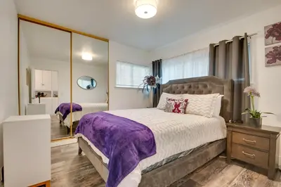 a bedroom with a large bed and a mirror at Inglewood Vacation Rental 2 Mi to Sofi Stadium in Inglewood