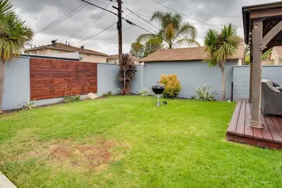 a backyard with a grill in the grass at Inglewood Vacation Rental 2 Mi to Sofi Stadium in Inglewood