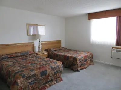 a hotel room with two beds and a window at Jet Inn in Los Angeles
