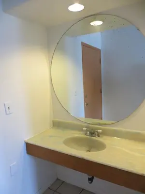 a bathroom with a sink with a large mirror at Jet Inn in Los Angeles