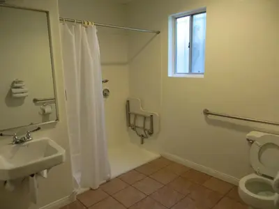 a bathroom with a shower and a toilet and a sink at Jet Inn in Los Angeles