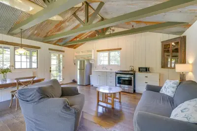 a kitchen with two couches and a table in a room at Farmhouse-Chic Carpinteria Cottage with Pool Access in Carpinteria