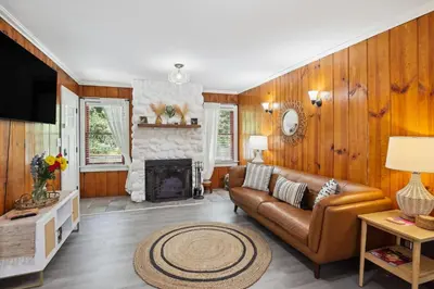 a living room with a couch and a fireplace at Twin Peaks Vacation Rental with Hot Tub! in Twin Peaks