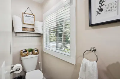 a bathroom with a toilet and a window at Twin Peaks Vacation Rental with Hot Tub! in Twin Peaks