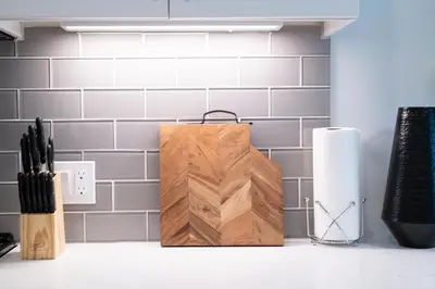 a wooden cutting board sitting on top of a counter at Comfy Apt with pool & hot tub in downtown LA 658 in Los Angeles