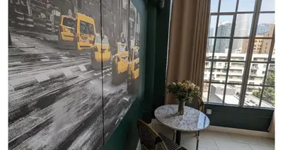 a table in a room with a painting of buses at NYC Styled Loft In DTLA, sleeps 4 with Free Parking! in Los Angeles