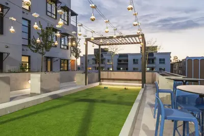 an outdoor patio with a lawn and a table and chairs at Level Hollywood in Los Angeles