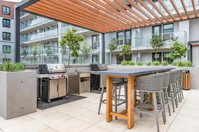 an outdoor kitchen with a table and chairs at Level Hollywood in Los Angeles