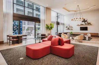 a living room with a red couch and a dining room at Level Hollywood in Los Angeles