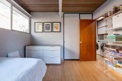 a bedroom with a bed and a closet at Eichler Mid Century Modern Designer Pool/Jacuzzi in Thousand Oaks