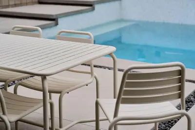 a table and chairs next to a swimming pool at Eichler Mid Century Modern Designer Pool/Jacuzzi in Thousand Oaks