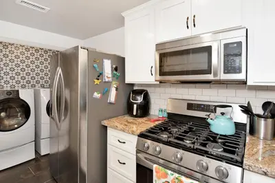 a kitchen with a stainless steel stove and a microwave at Maltby Modern Log Cabin Relaxing Chalet Retreat in Big Bear Lake