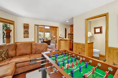 a living room with a couch and a foosball table at Lakefront Village Castle- Foosball- Boat Dock- in Big Bear Lake