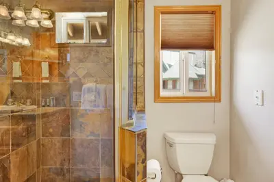 a bathroom with a toilet and a shower at Lakefront Village Castle- Foosball- Boat Dock- in Big Bear Lake