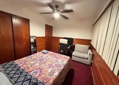 a bedroom with a bed and a ceiling fan at Room in Monterey Park CA in Monterey Park