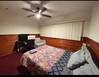 a bedroom with a bed and a ceiling fan at Room in Monterey Park CA in Monterey Park