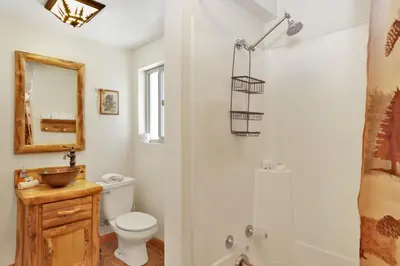 a bathroom with a toilet and a shower at Moonridge R n R- Cozy Single Level Central Chalet Home in Big Bear Lake