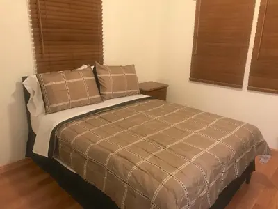 a bedroom with a bed with two pillows at House Rooms & RV Rooms Near LAX in Los Angeles