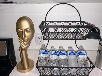 a bunch of water bottles in a basket next to a trophy at Downtown Los Angeles Skyline balcony view Modern Penthouse in Los Angeles