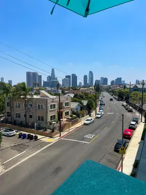 a view of a city street with buildings and cars at Downtown Los Angeles Skyline balcony view Modern Penthouse in Los Angeles