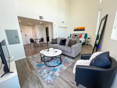 a living room with a couch and a table at Downtown Los Angeles Skyline balcony view Modern Penthouse in Los Angeles
