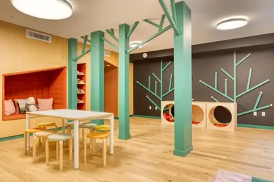 a room with a table and chairs and trees on the wall at Hollywood studio w pool concierge nr shops LAX-1088 in Los Angeles