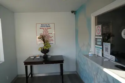 a room with a table with a plant on it at Avenue Motel in Gardena