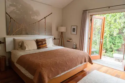 a bedroom with a bed and a large window at Casa Superba - Peaceful Sanctuary in Venice in Los Angeles