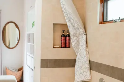 a bathroom with two bottles on a wall at Casa Superba - Peaceful Sanctuary in Venice in Los Angeles