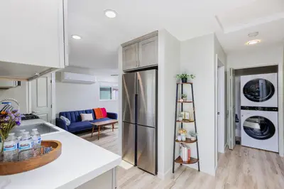 a kitchen and living room with a stainless steel refrigerator at Cozy and Quiet Front House in Fontana