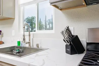 a kitchen counter with a sink and a window at Cozy and Quiet Front House in Fontana