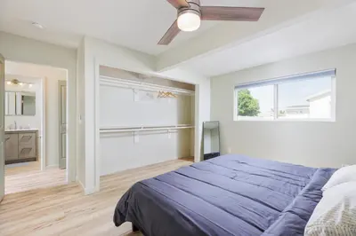 a bedroom with a large bed and a window at Cozy and Quiet Front House in Fontana