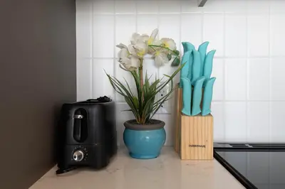 a plant in a blue vase next to a stove at Spacious 3Bedroom Apt close to LAX & Sofi Stadium* in Los Angeles