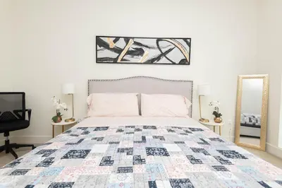 a bedroom with a bed and a mirror at Spacious 3Bedroom Apt close to LAX & Sofi Stadium* in Los Angeles