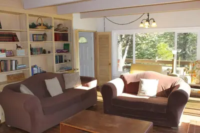 a living room with two couches and a coffee table at Beautiful Lake View House for rent! in Lake Arrowhead