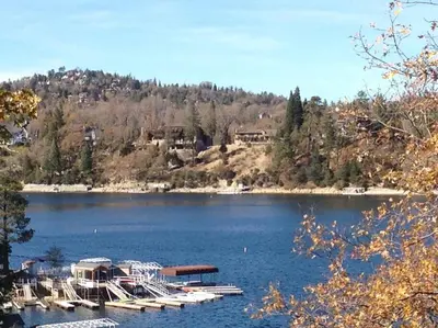 a group of boats docked on a lake at Beautiful Lake View House for rent! in Lake Arrowhead