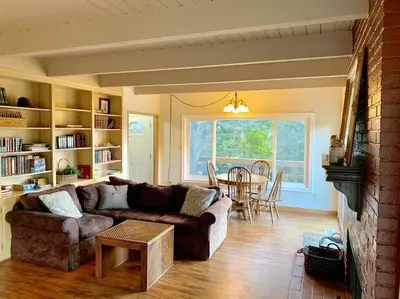 a living room with a couch and a table at Beautiful Lake View House for rent! in Lake Arrowhead