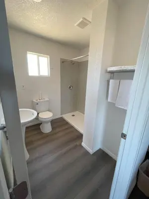 a bathroom with a toilet and a sink at Palm Inn in Mojave