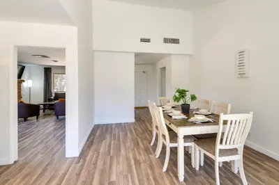 a dining room and living room with a table and chairs at Quiet Ridgecrest Vacation Rental with Private Yard! in Ridgecrest