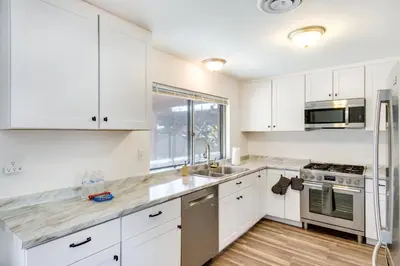 a kitchen with white cabinets and a sink at Quiet Ridgecrest Vacation Rental with Private Yard! in Ridgecrest