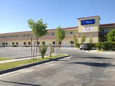 an empty parking lot in front of a building at America Inn & Suites in Ridgecrest