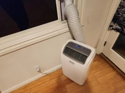 a air conditioner sitting on the floor next to a window at Hollywood Hills Hideout Apartment! in Los Angeles