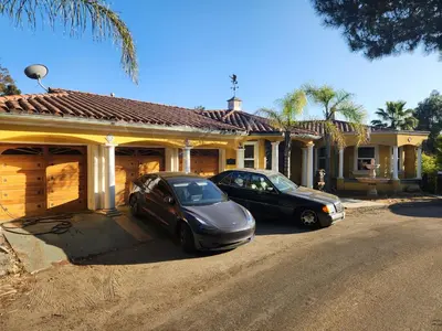 two cars parked in front of a house at Hollywood Hills Hideout Apartment! in Los Angeles