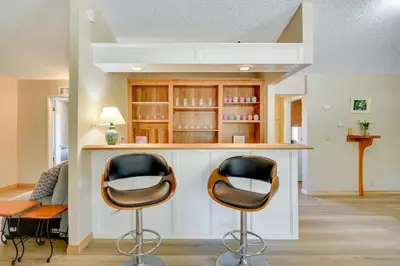 a kitchen with two chairs at a counter at Tranquil Maricopa Retreat with Pool and Hot Tub in Maricopa