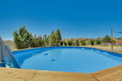 a large blue swimming pool in a yard at Tranquil Maricopa Retreat with Pool and Hot Tub in Maricopa