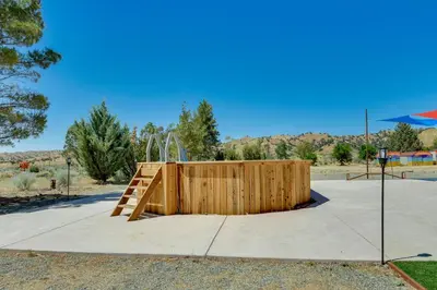 a wooden play area with a wooden staircase in a park at Tranquil Maricopa Retreat with Pool and Hot Tub in Maricopa