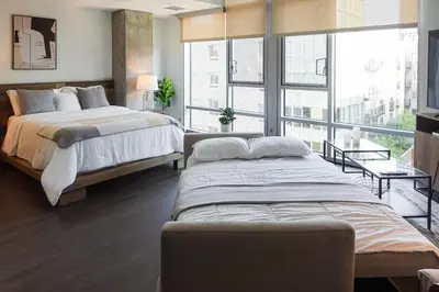 a bedroom with two beds and a large window at Luxurious Hollywood Dream in Los Angeles
